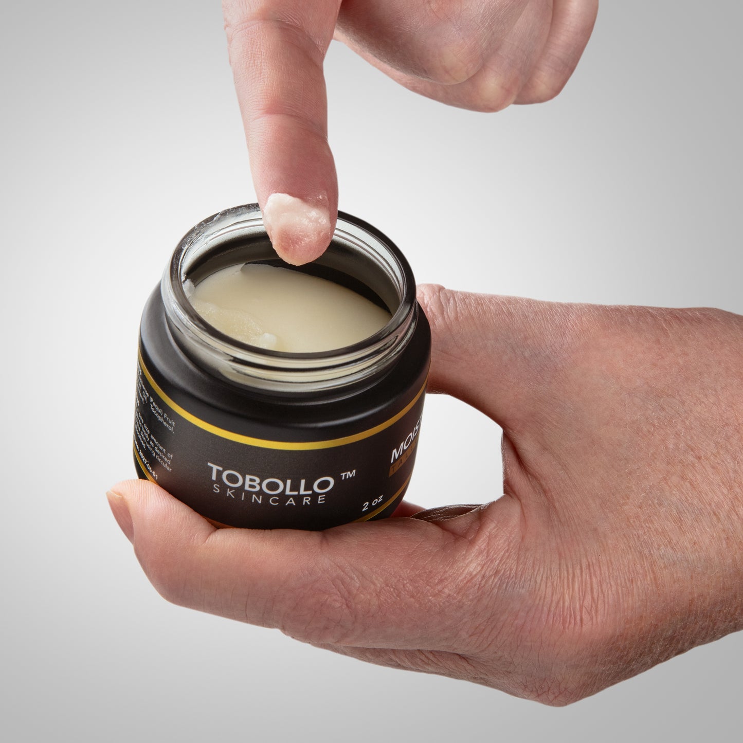 beef tallow moisturizer applied on hand for dry skin hydration.